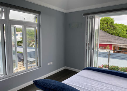 Situated on the top level, the Primary King Bedroom features a King sized bed, sleeping up to 2 people.  Guests in this room enjoy a balcony and views of the pool, jacuzzi, and Great Room. Each room at isanti is accompanied by a private en suite bathroom.