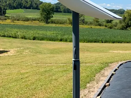 Starlink dish professionally mounted on a pole with tidy cabling