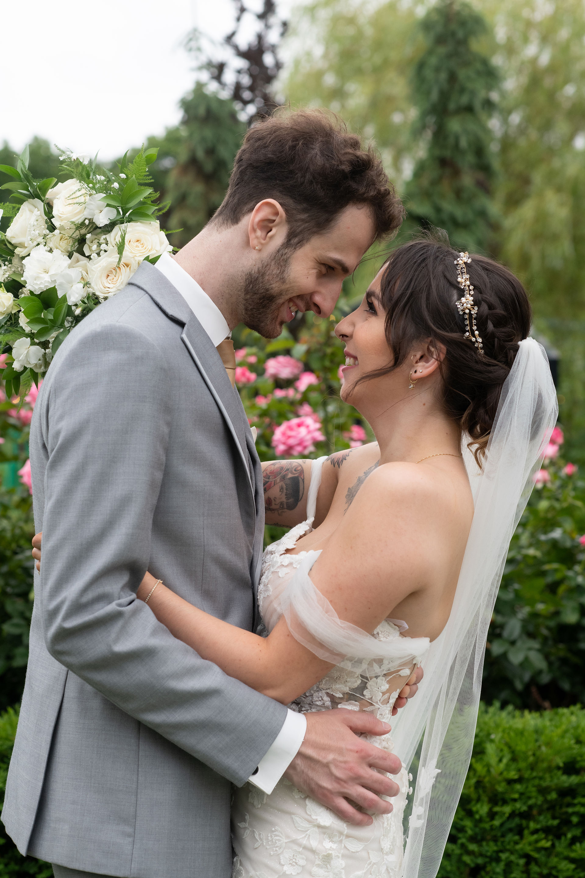 Romantic bride and groom portrait at Pillar and Post rose garden by Niagara wedding photographer