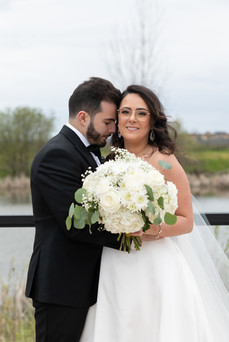 Newly married couple embracing in the vineyard rows at sunset in Niagara-on-the-Lake.