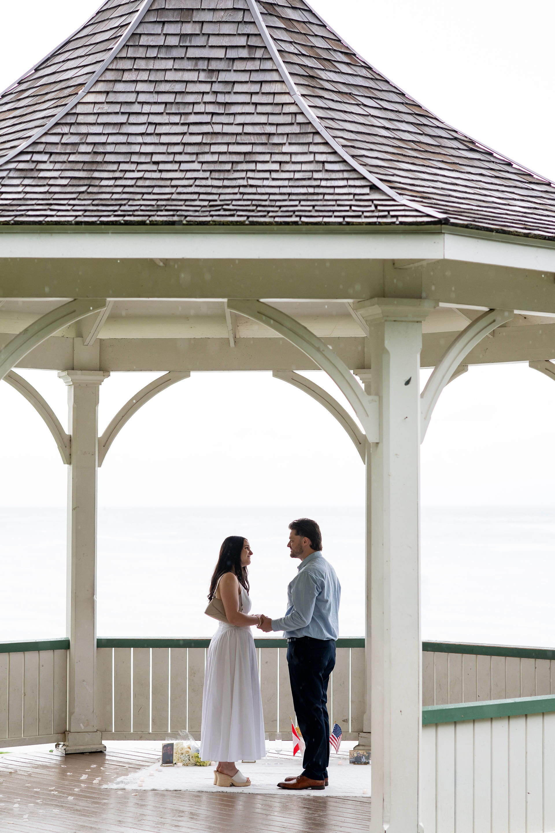 Surprise proposal in a lakeside gazebo on a rainy day in Niagara-on-the-Lake.