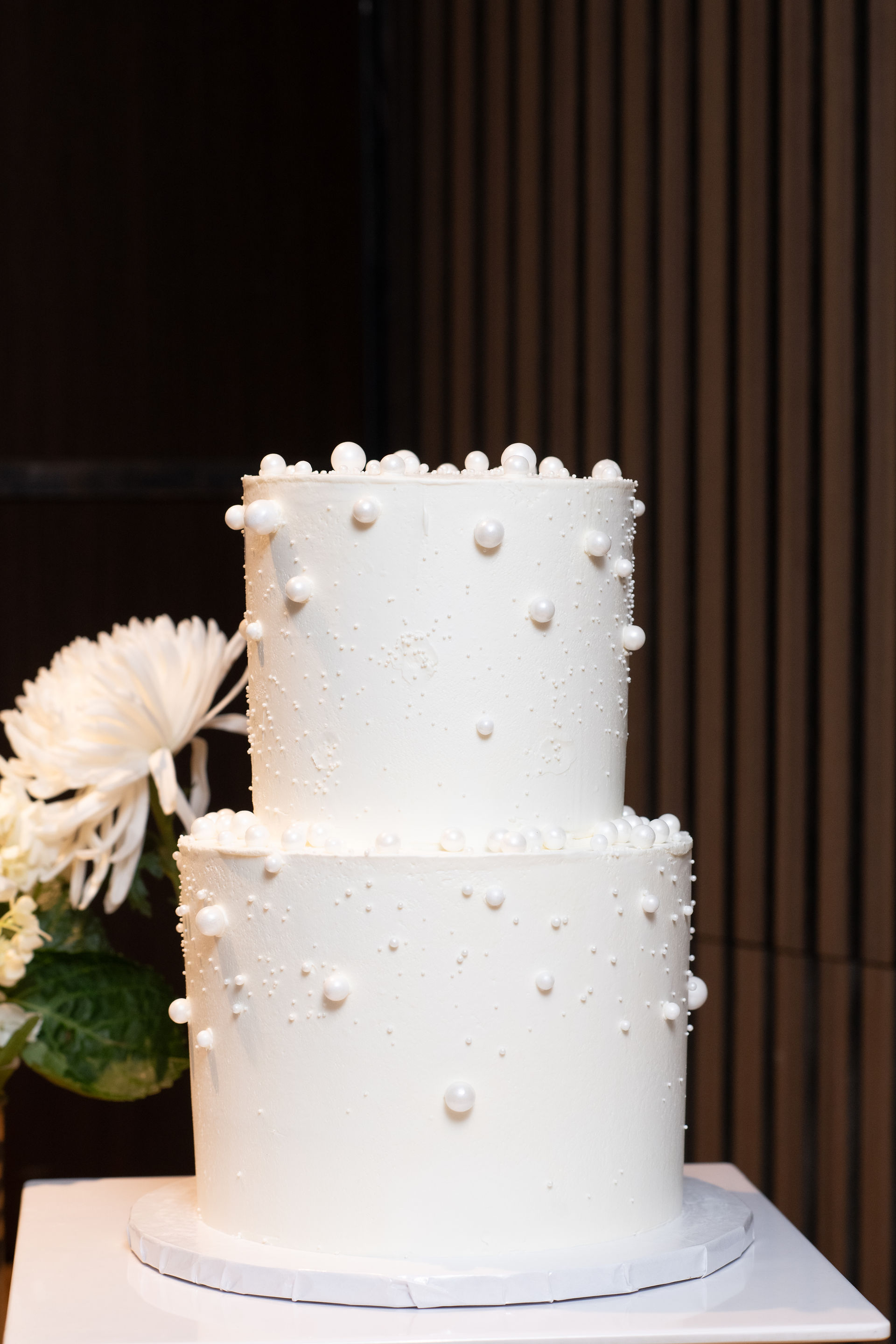 Wedding couple celebrating with family and friends during Niagara vineyard wedding reception.