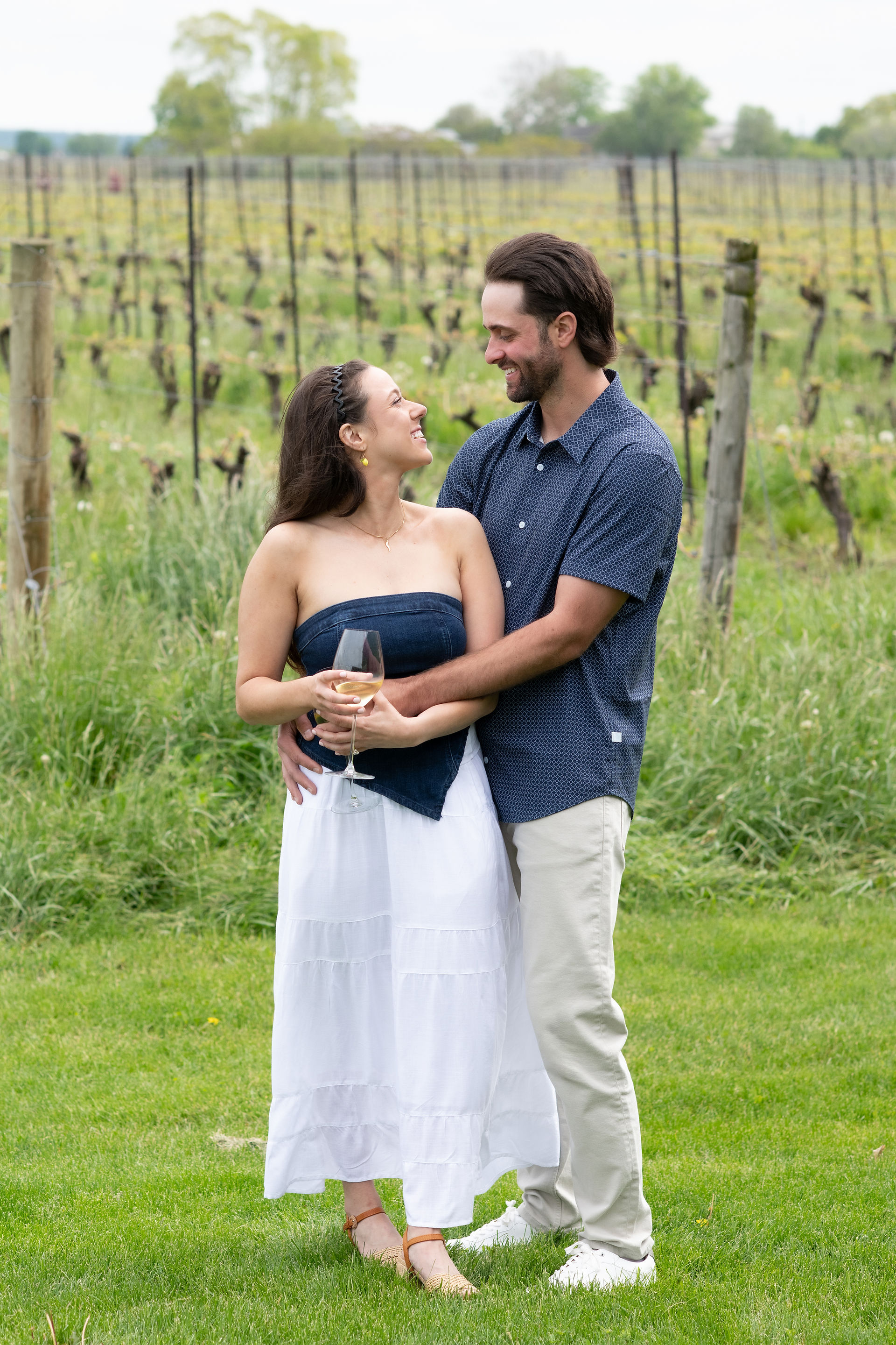 Natural engagement portraits captured after a surprise proposal at a Niagara winery.