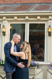 Romantic portrait of an engaged couple walking through downtown Niagara-on-the-Lake.