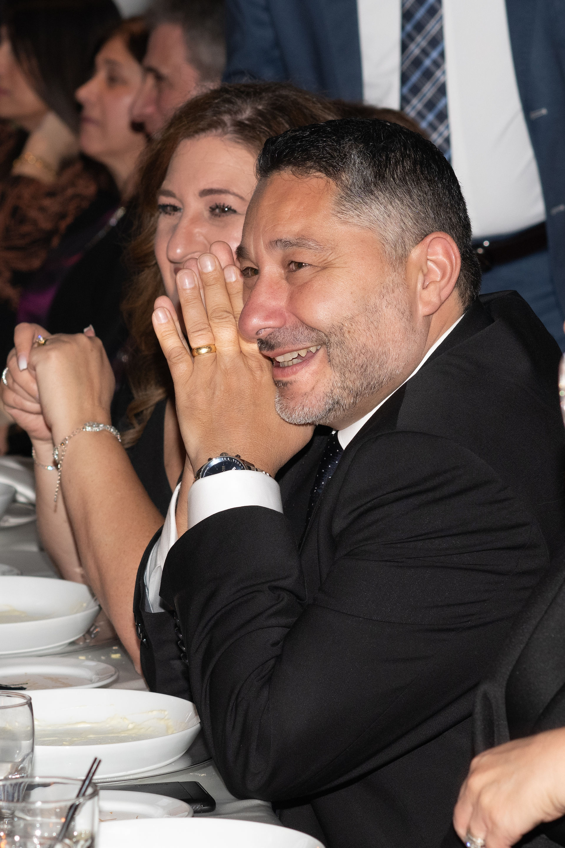 Wedding couple celebrating with family and friends during Niagara vineyard wedding reception.