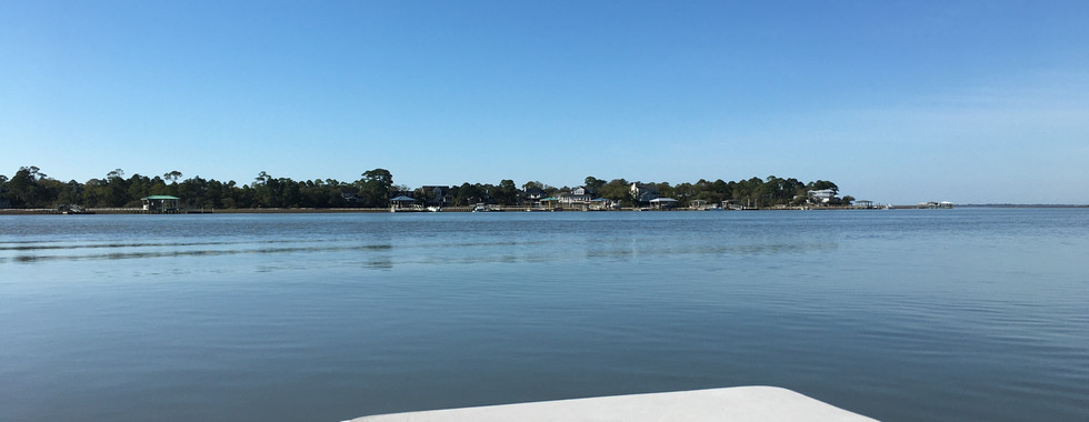 a view over looking the water and marshes outside charleston south carolina from inside a skiff boat
