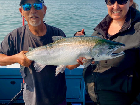A big, beautiful northern Coho for this happy charter client