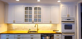 White kitchen cabinets, gold hardware, and quartz countertop