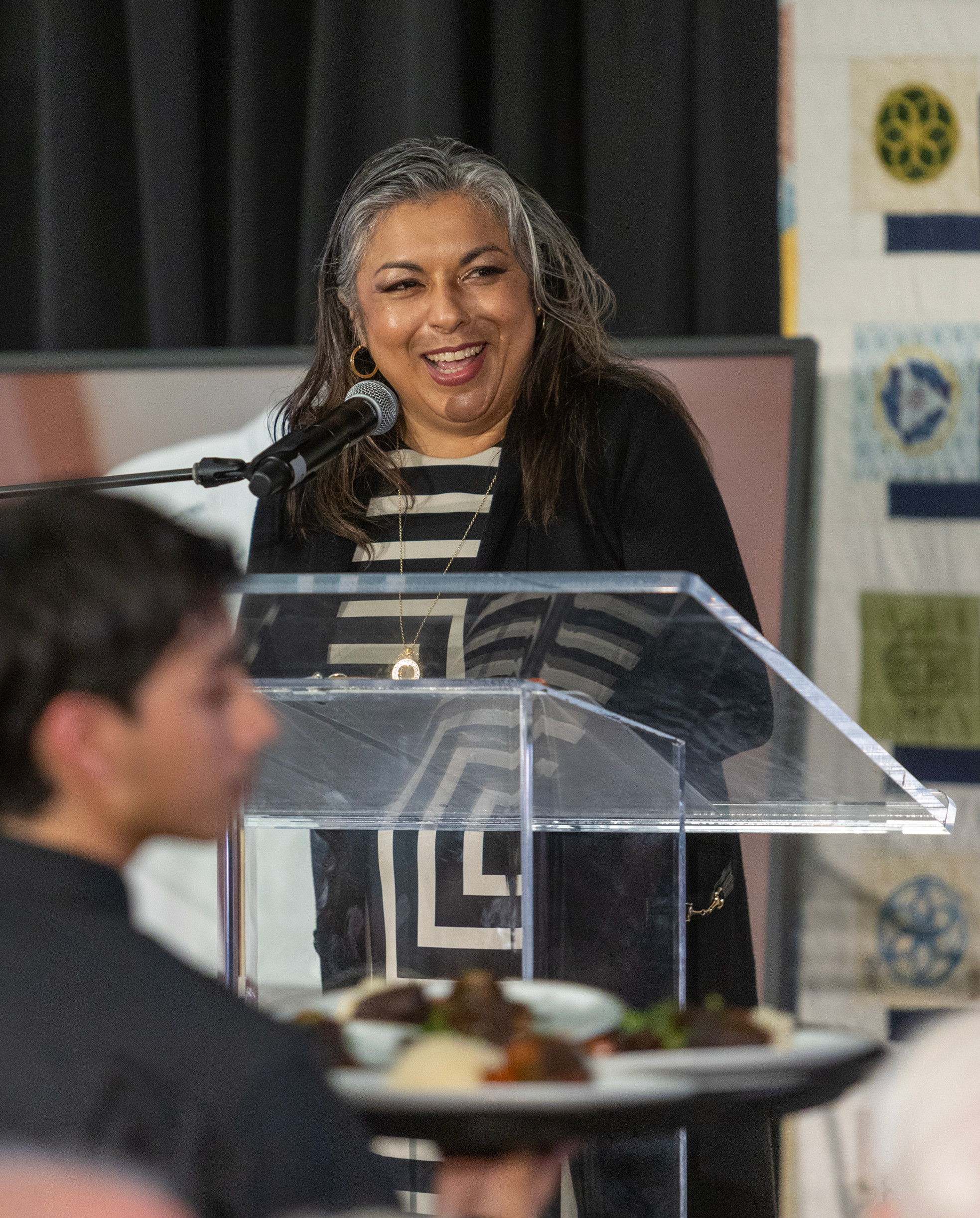 Beacon Board member and Brigid's Hope graduate Ursula Hernandez shares her story of lived experience from the stage.