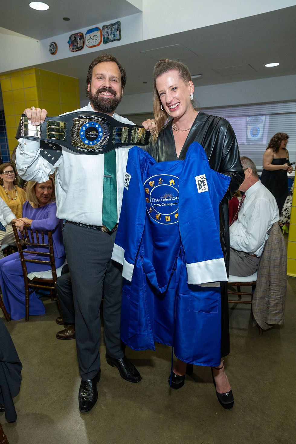 Beacon Champion winners Matt and Amy Matusek take a photo with "Bob's Belt" our WWE-style perpetual trophy belt, and the custom championship robe.