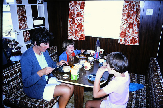 a family photo taken in the 70's of a static caravan interior with a family having breakfast