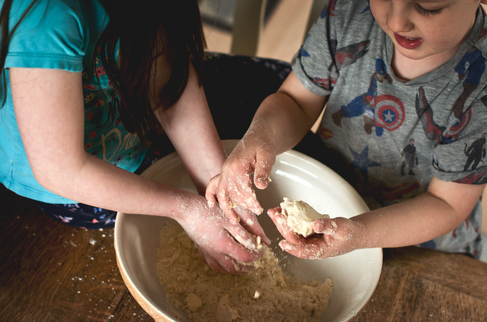 children using their hands to bake for a family photo
