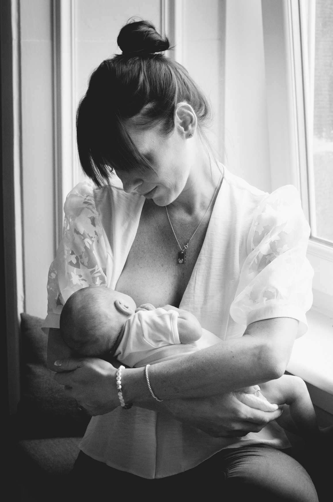 breast feeding mother in window