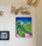 Bright green monstera leaves with tropical sunset painting