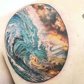 Wave crashing in the ocean stormy skies behind blue water yellow and orange sky in a circular frame back piece original artwork Mad Rabbit Hustle Butter custom design colour tattoo colourful experienced tattoo artist cover up tattoo fix up created by Derek Lewis at Lewis Family Tattoo Company using Better Butter Care tattoo glide and aftercare Flame Wise Ink Heartless Ink Hartless Ink Chronic Ink Tattoo People Tattoo Junction New Tribe Tattoo Toronto tattoo studio tattoo shop Dundas West Roncesvalles Ave