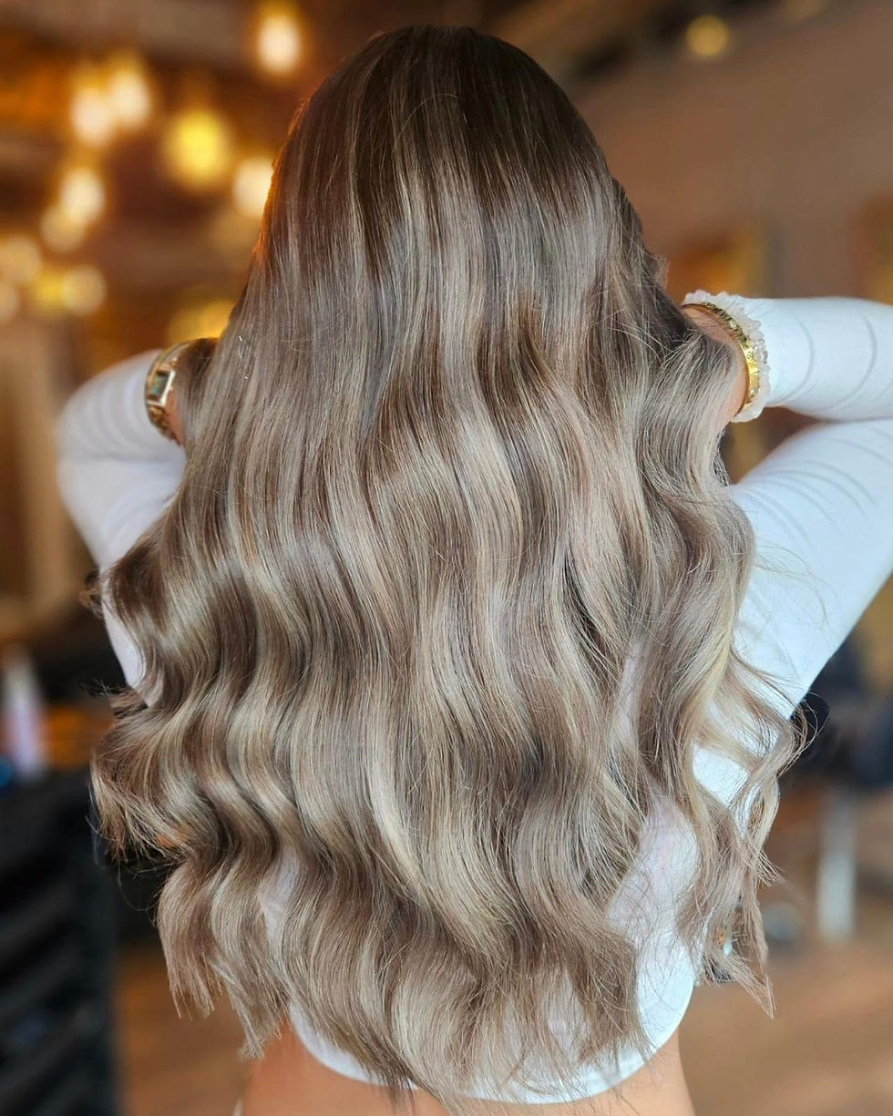 Eye-level view of softly blended balayage hair in a salon chair
