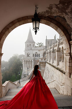 Flying dress photoshoot with flowing red fabric at Fisherman’s Bastion in Budapest.
