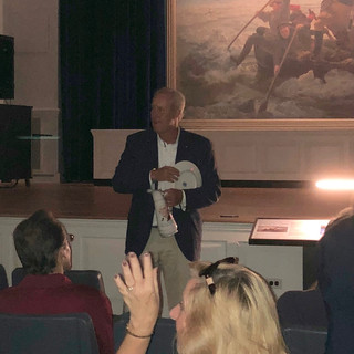 Charles Scammell addressing the attendees in the auditorium prior to the short film "Of Dire Necessity