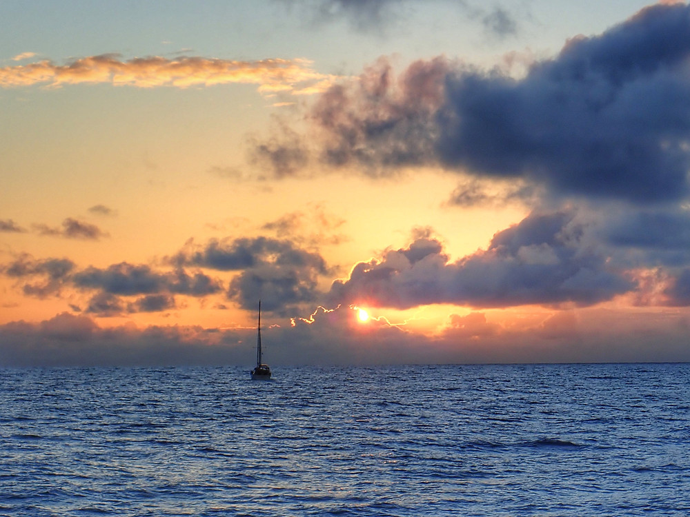Now in safe waters, the group sails into the sunset