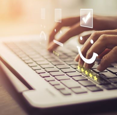 Person Typing on a Laptop Featuring a Smiley