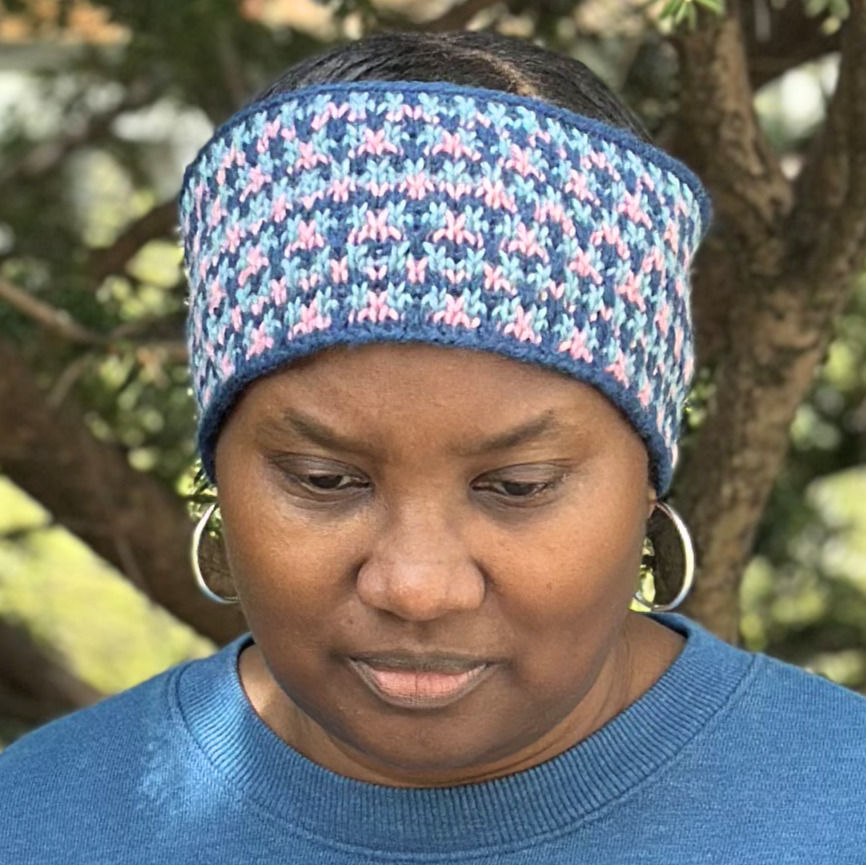 A three-color slip-stitch headband adds a vibrant touch with its stitch pattern knit in shades of blue, pink, and turquoise, perfect for outdoor wear.