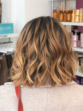 Warm blonde highlights on a wavy bob