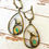 Thumbnail: Artisan Emerald Dolphin Play Earrings
