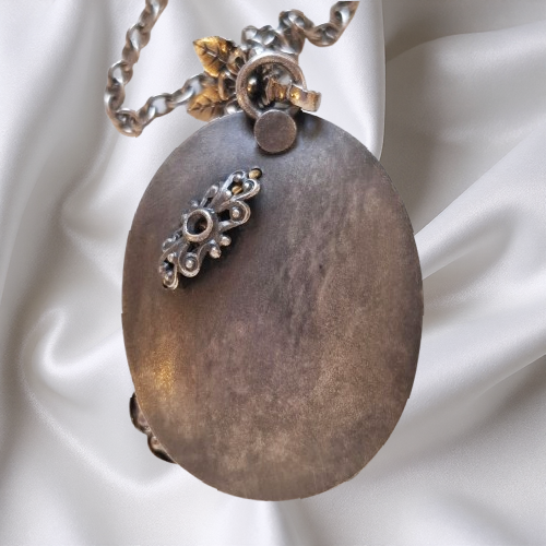 Thumbnail: Vintage floral pendant necklace with a blue oval glass stone and silver-tone floral detailing