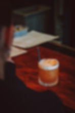 Eye-level view of a Thai Basil Mojito cocktail with fresh basil leaves
