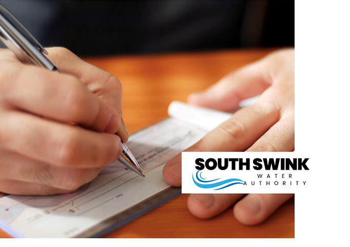 This is a close up photo of a person's hands writing a check, the South Swink Water Authority logo is over the photo at the bottom right hand corner.
