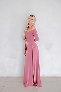 Bridesmaid wearing the Gelique Isabel Dress in a dusty rose colour — a romantic off-the-shoulder gown with fitted sleeves, a soft corset-like bodice, and a luxuriously flowing full-length skirt. This elegant, feminine silhouette enhances movement and creates a timeless look perfect for weddings, matric dances, and formal occasions.