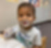Happy baby at daycare with fingers in his mouth in the infant classroom