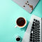 Teal background with coffee and laptop.jpg