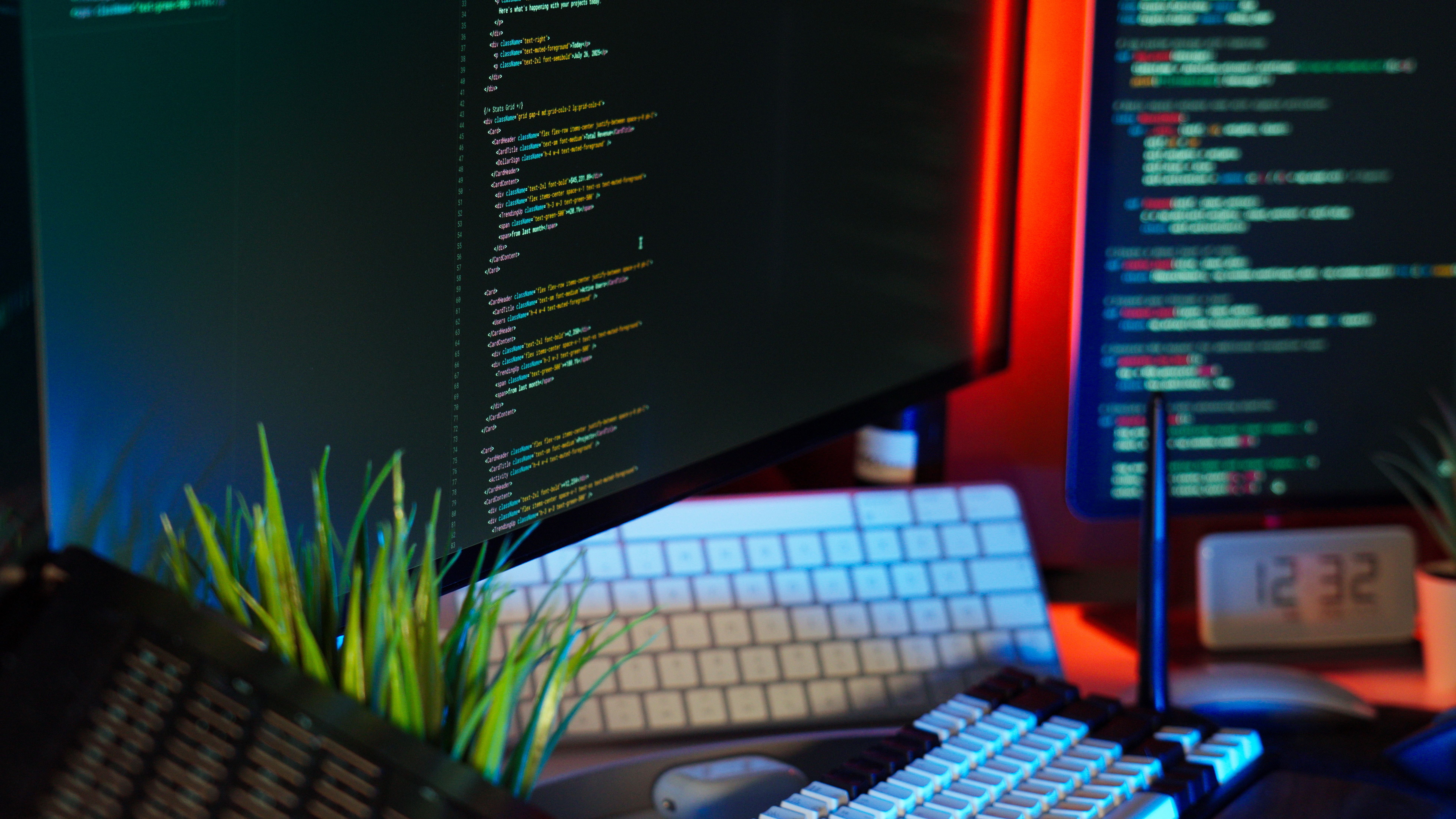 Digital artist working at a multi-screen workstation on a game environment