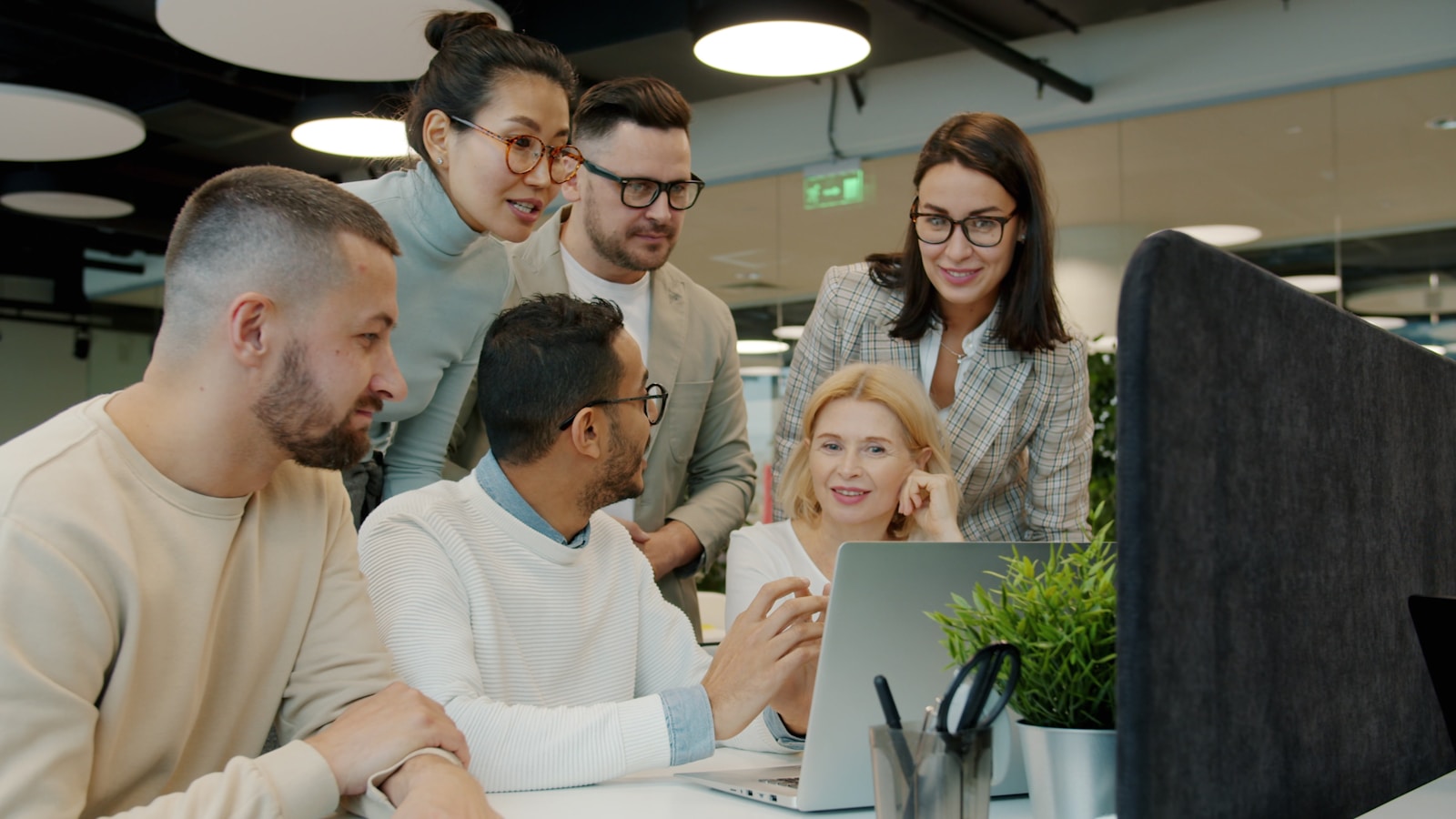 Creative and technical team comparing co-development plans on a shared screen
