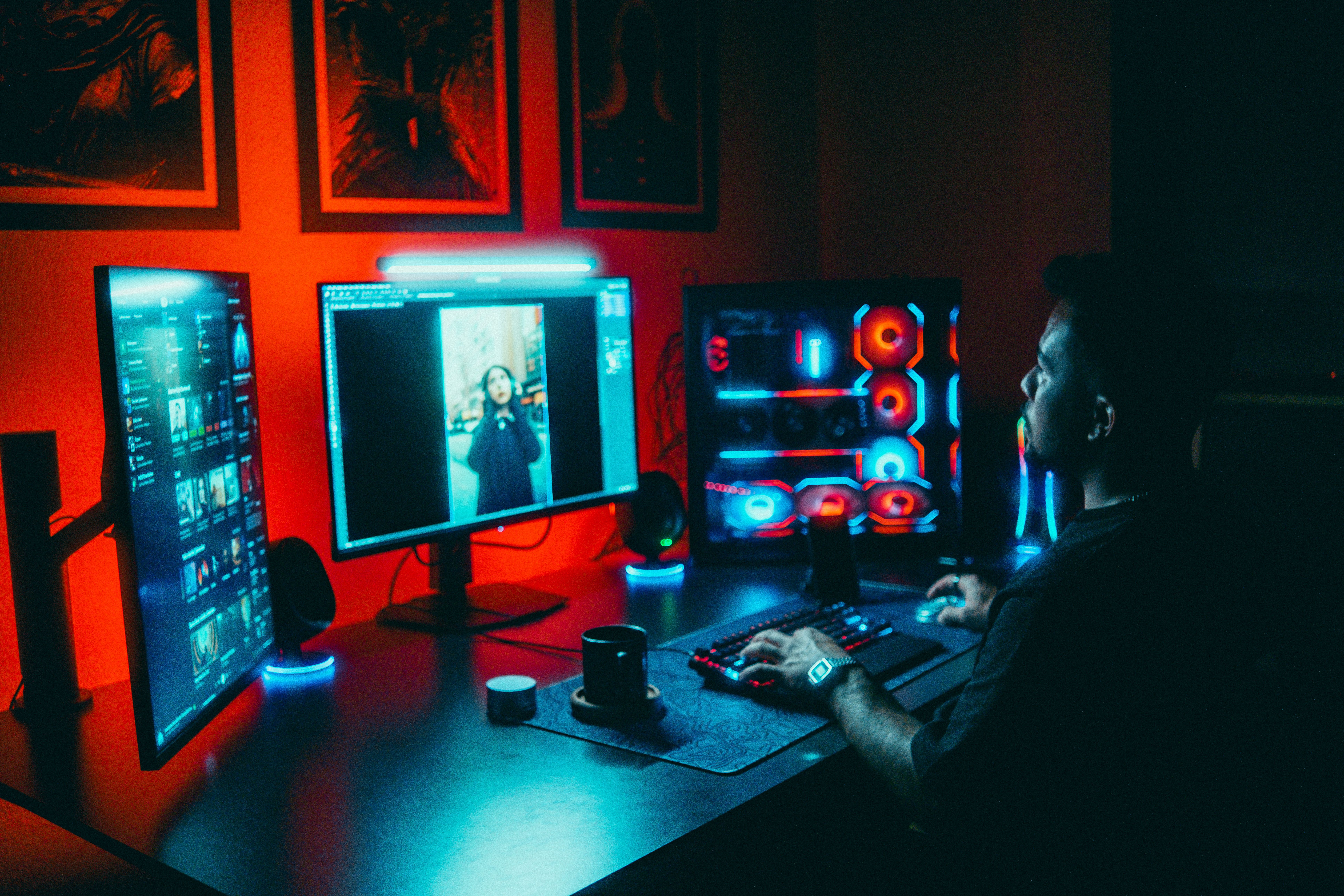 Game developer reviewing environment references at a neon-lit workstation