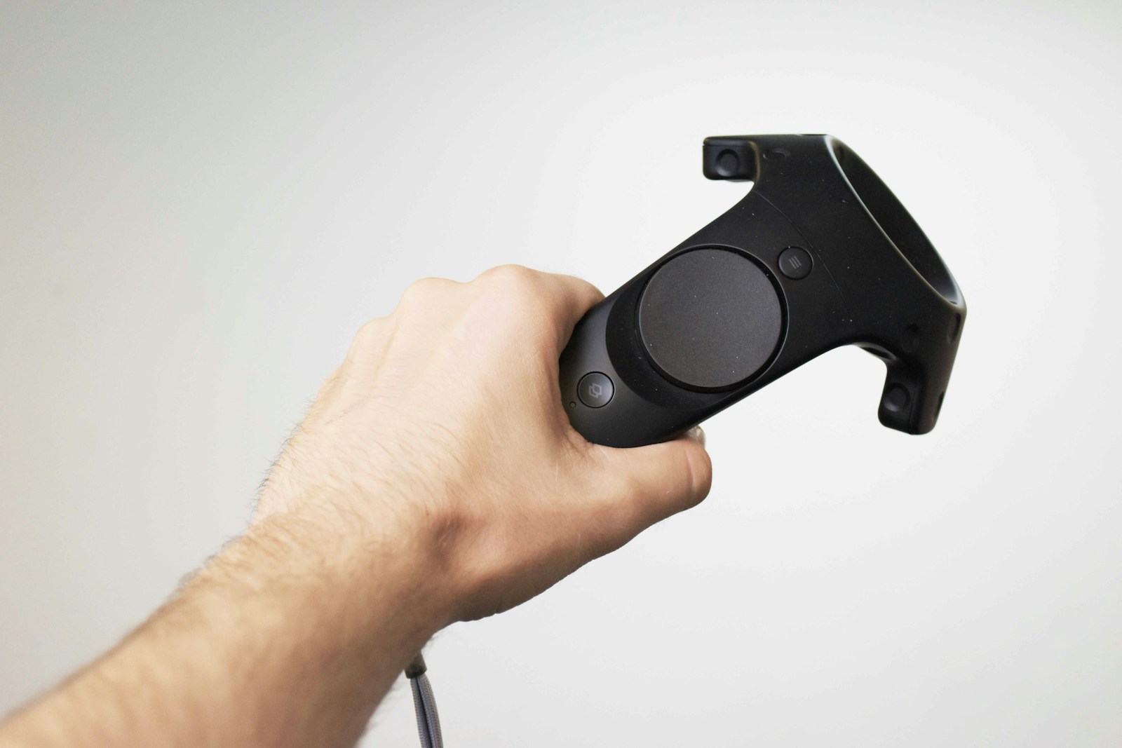 Hand gripping an HTC Vive motion controller