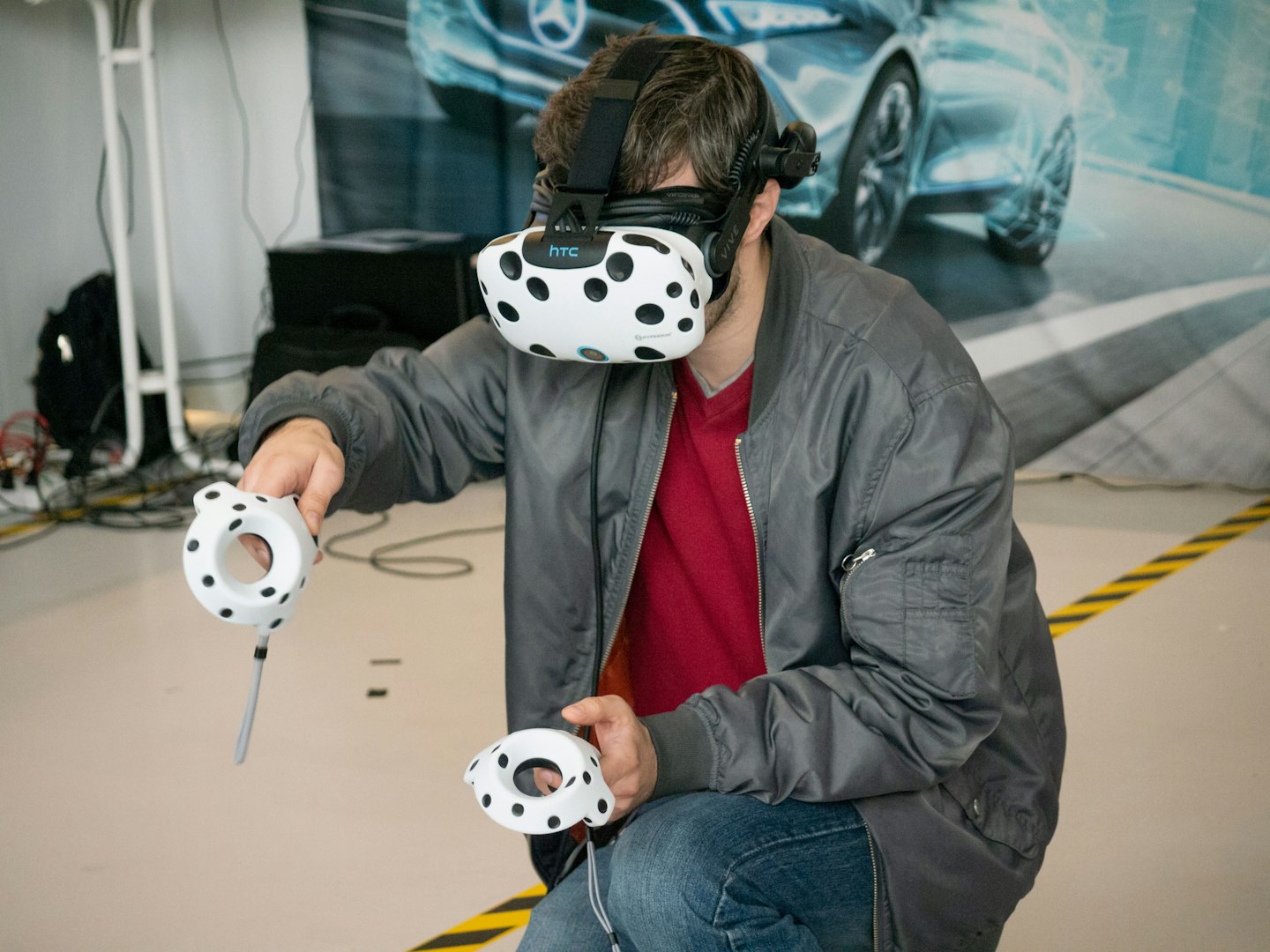 Visitor trying a VR headset and hand controllers at XR Expo in Stuttgart