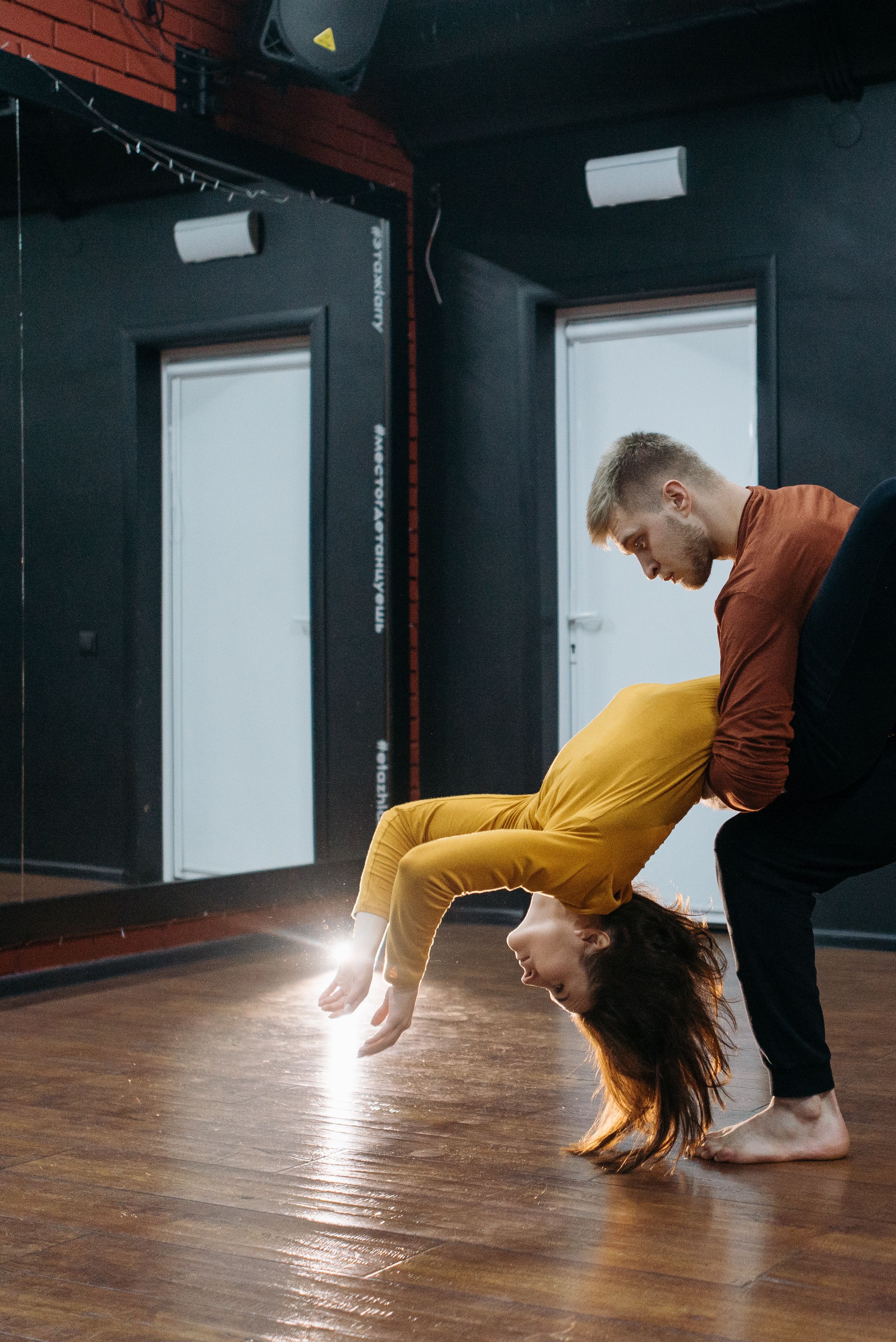 Two dancers rehearsing together, showing timing and coordinated movement