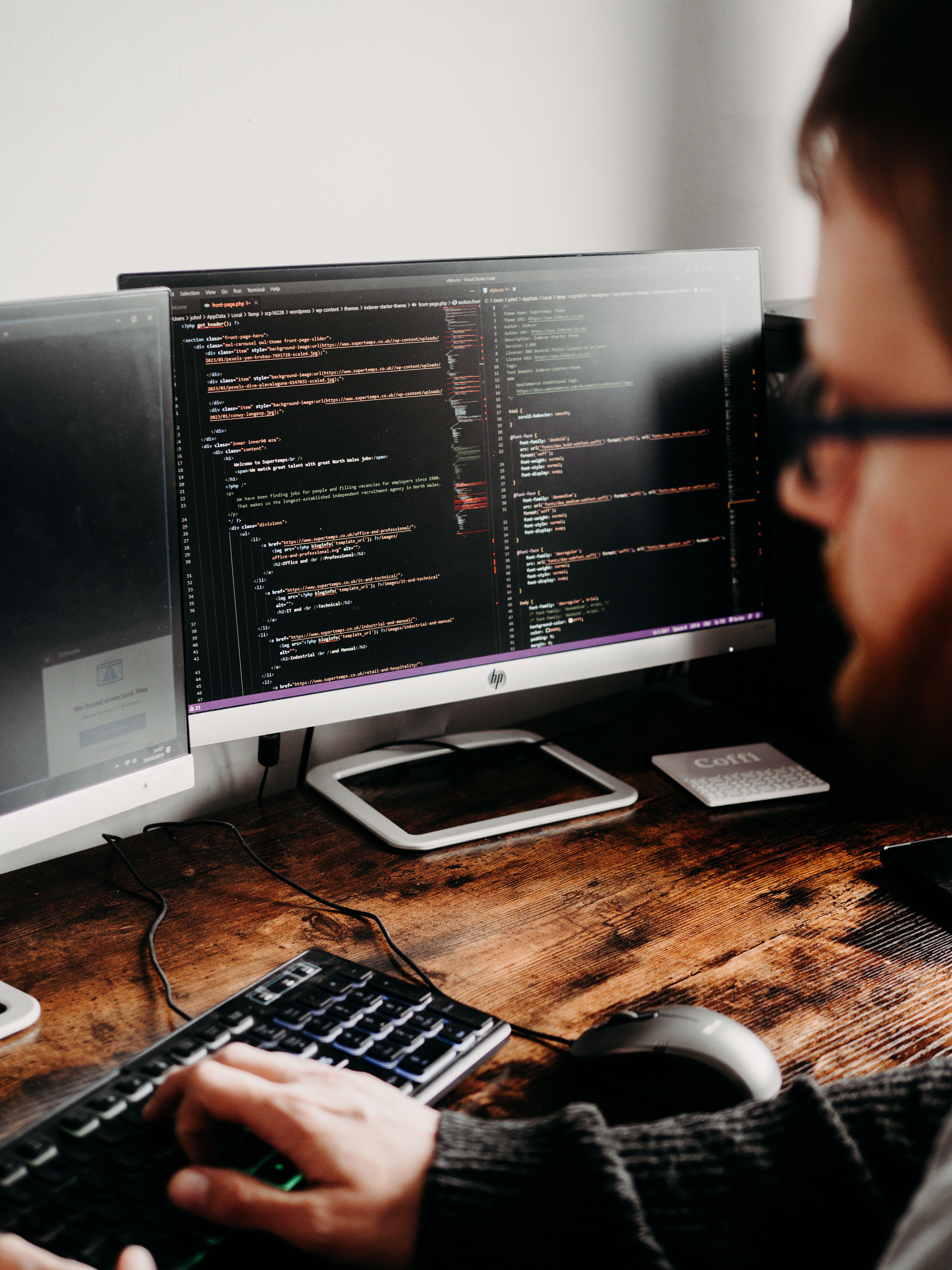 Developer reviewing a virtual game space across multiple monitors