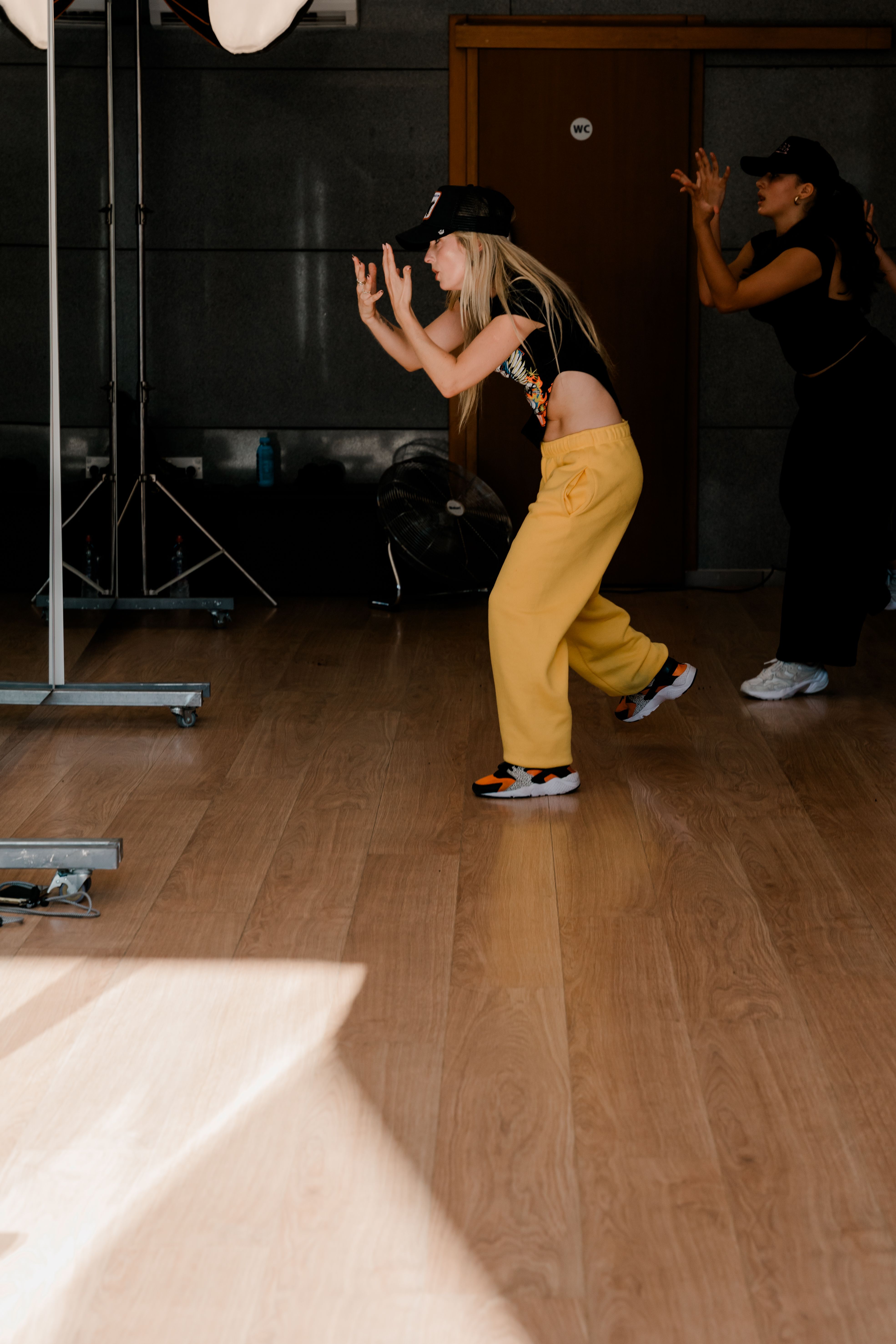 Two dancers rehearsing movements in a studio, illustrating performed motion