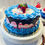 Thumbnail: Dezicakes Fake Cake Red White Blue Cake with Strawberries