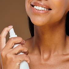 beautiful-african-american-woman-with-brunette-hair-applying-skincare-studio-setting.jpg