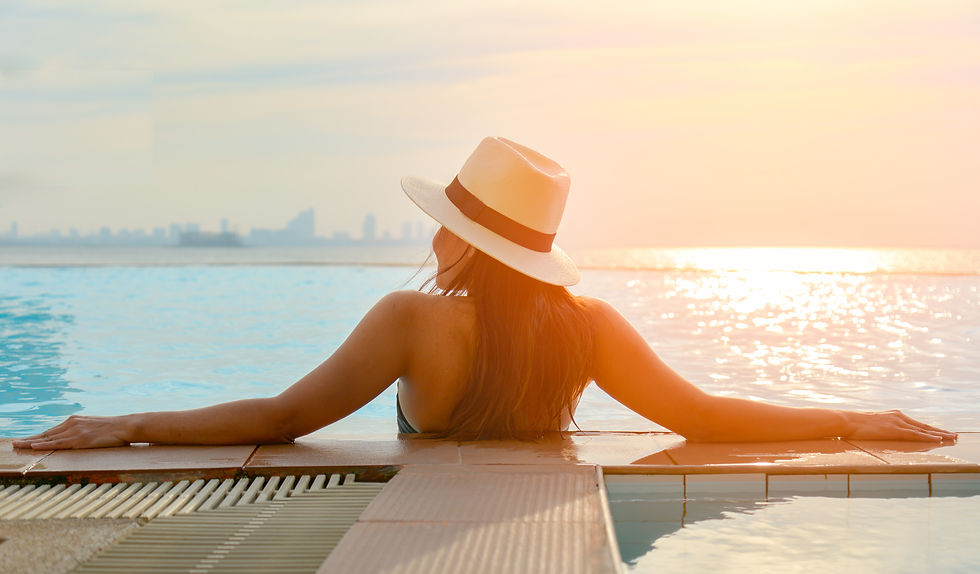 rear-view-woman-enjoying-swimming-pool-against-sky.jpg
