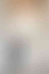 Happy bride and groom standing together under stone arches