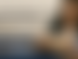 Professional woman reading an employee handbook at a desk, promotional banner for HRLearns workshop titled 'Employee Handbooks Unveiled'