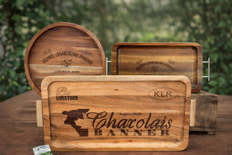 Three wooden serving trays engraved with Red Livestock, Charolais Banner August 2023, and Coronado Basin.