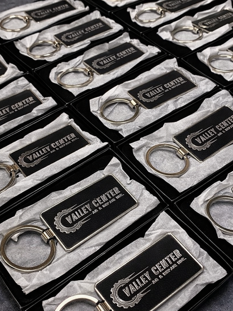 Black keychains with 'VALLEY CENTER' logo in boxes