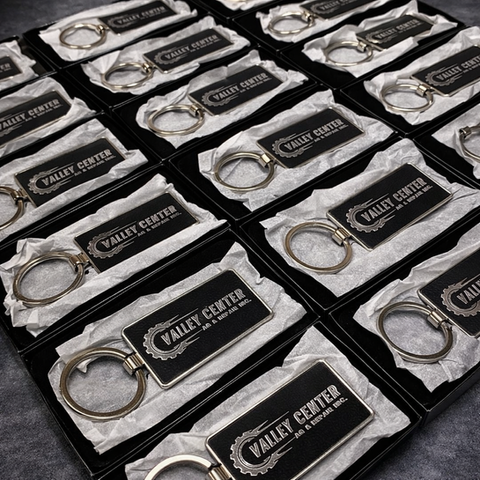 Black keychains with 'VALLEY CENTER' logo in boxes