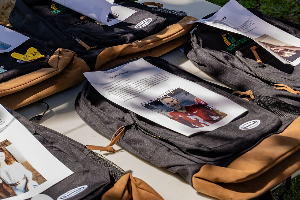 A picture of a college athlete laid neatly on a backpack during an event by Faces of Suicide on campus during Suicide Prevention Awareness Month on September 16.
